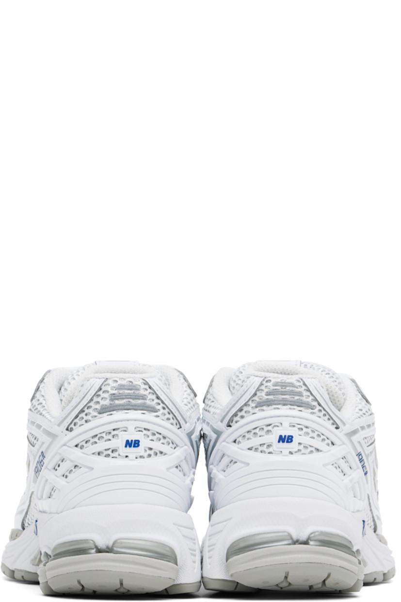 Low-top mesh and faux-leather sneakers in white.

· Lace-up closure
· Logo patch at padded tongue
· Padded collar
· Logo appliqué at sides and heel counter
· Ortholite® footbed
· Mesh lining
· Stability Web arch support
· ABZORB SBS cushioning at heel
· ACTEVA LITE foam rubber midsole
· Treaded N-ergy rubber sole

Supplier color: White/Team royal/Silver metallic