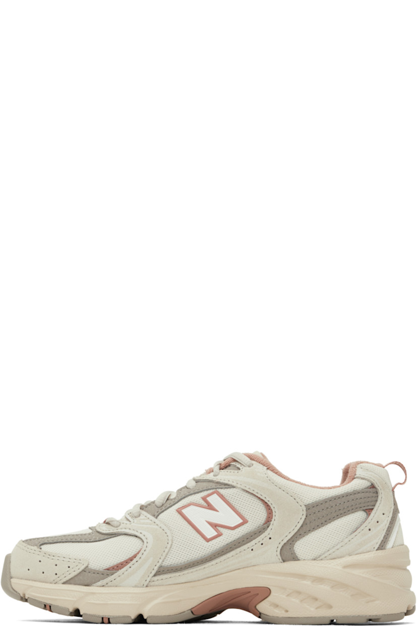Low-top mesh and suede sneakers in gray and pink.

· Perforations throughout
· Lace-up closure
· Logo stamp at padded tongue
· Padded collar
· Reflective logo appliqué at sides
· Pull-loop at heel collar
· Fleece lining
· Textured ABZORB® rubber midsole
· Treaded rubber sole

Supplier color: Grey/Beige