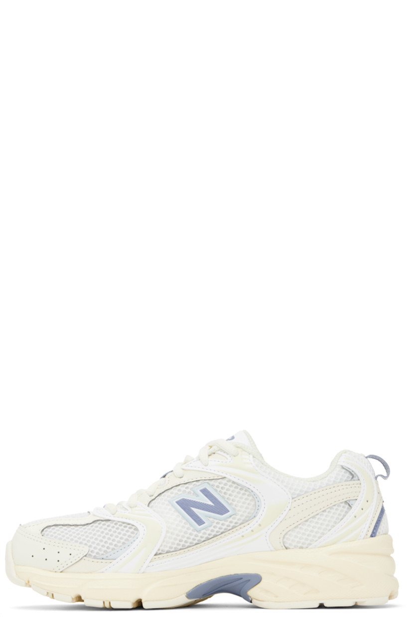 Low-top semi-sheer mesh and grained faux-leather sneakers in off-white and blue.

· Perforations throughout
· Lace-up closure
· Logo printed at padded tongue
· Padded collar
· Rubberized logo appliqué at sides
· Text embossed at outer side
· Pull-loop at heel tab
· Mesh lining
· ABZORB foam rubber midsole
· Treaded rubber sole

Supplier color: Angora/Dusk shower/Ice blue