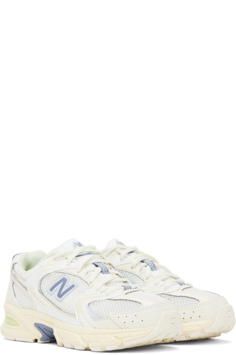 Low-top semi-sheer mesh and grained faux-leather sneakers in off-white and blue.

· Perforations throughout
· Lace-up closure
· Logo printed at padded tongue
· Padded collar
· Rubberized logo appliqué at sides
· Text embossed at outer side
· Pull-loop at heel tab
· Mesh lining
· ABZORB foam rubber midsole
· Treaded rubber sole

Supplier color: Angora/Dusk shower/Ice blue
