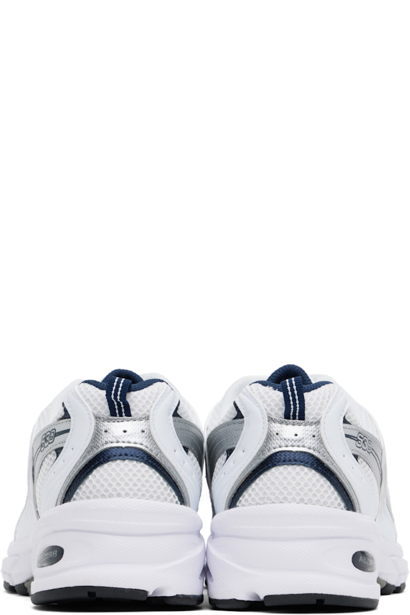 Low-top mesh and faux-leather sneakers in white and silver tone.

· Perforated detailing throughout
· Lace-up closure
· Logo printed at padded tongue
· Padded collar
· Logo appliqué at sides
· Pull-loop at heel tab
· Mesh lining
· Sculptural ABZORB® rubber midsole
· Logo embossed at treaded rubber sole

Supplier color: White/Natural indigo