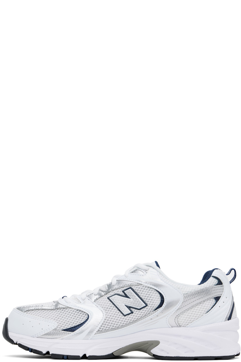 Low-top mesh and faux-leather sneakers in white and silver tone.

· Perforated detailing throughout
· Lace-up closure
· Logo printed at padded tongue
· Padded collar
· Logo appliqué at sides
· Pull-loop at heel tab
· Mesh lining
· Sculptural ABZORB® rubber midsole
· Logo embossed at treaded rubber sole

Supplier color: White/Natural indigo