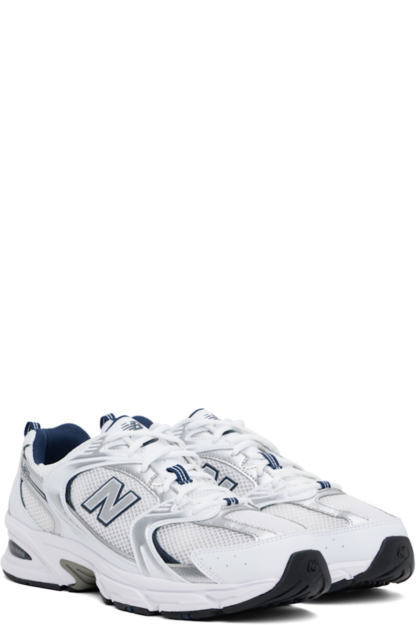 Low-top mesh and faux-leather sneakers in white and silver tone.

· Perforated detailing throughout
· Lace-up closure
· Logo printed at padded tongue
· Padded collar
· Logo appliqué at sides
· Pull-loop at heel tab
· Mesh lining
· Sculptural ABZORB® rubber midsole
· Logo embossed at treaded rubber sole

Supplier color: White/Natural indigo