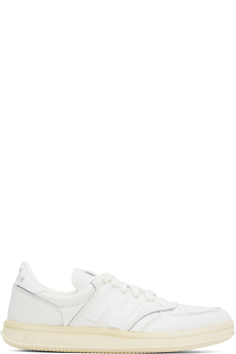 Low-top buffed leather sneakers in off-white.

· Perforated detailing at toe
· Lace-up closure
· Logo patch at tongue
· Padded collar
· Logo appliqué at sides
· Logo printed at heel tab
· Buffed leather and mesh lining
· Logo embossed at textured rubber midsole
· Treaded rubber sole

Supplier color: Sea salt/White/Angora