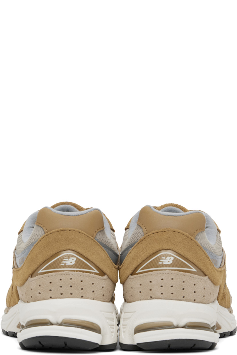 Low-top suede and mesh sneakers in tan.

· Logo embroidered at vamp
· Lace-up closure
· Inset logo patch at padded tongue
· Padded collar
· Reflective logo appliqué at sides
· Perforated detailing at heel counter
· Jersey lining
· ABZORB® foam rubber midsole
· Treaded N-ergy rubber sole
· Stability Web technology at sole

Supplier color: Great plains/Incense/Slate grey