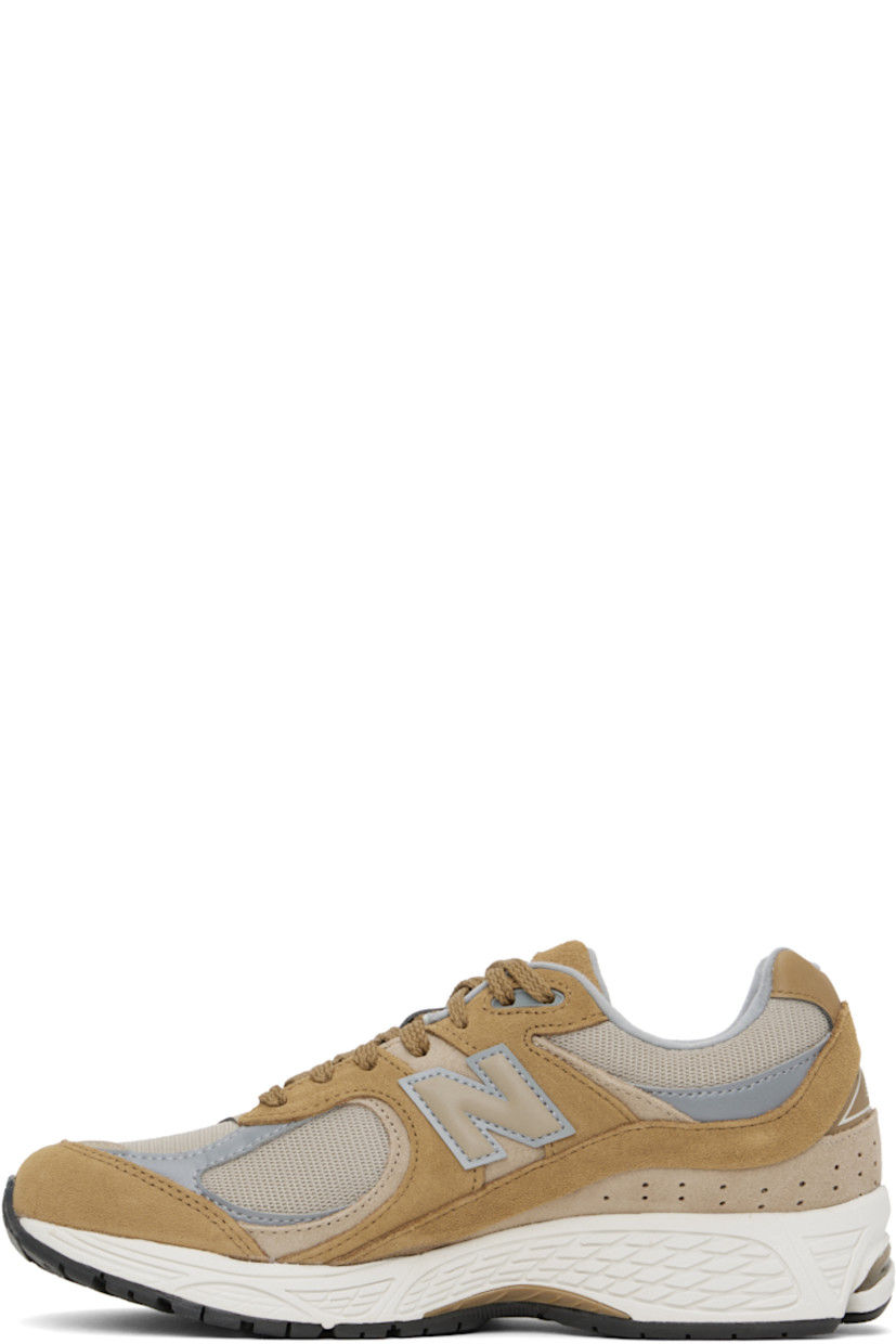 Low-top suede and mesh sneakers in tan.

· Logo embroidered at vamp
· Lace-up closure
· Inset logo patch at padded tongue
· Padded collar
· Reflective logo appliqué at sides
· Perforated detailing at heel counter
· Jersey lining
· ABZORB® foam rubber midsole
· Treaded N-ergy rubber sole
· Stability Web technology at sole

Supplier color: Great plains/Incense/Slate grey