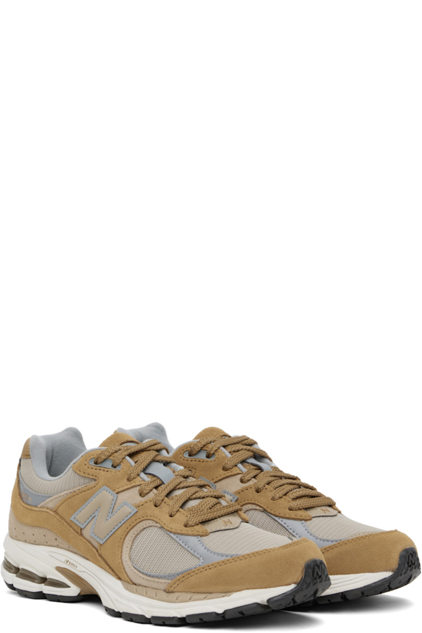 Low-top suede and mesh sneakers in tan.

· Logo embroidered at vamp
· Lace-up closure
· Inset logo patch at padded tongue
· Padded collar
· Reflective logo appliqué at sides
· Perforated detailing at heel counter
· Jersey lining
· ABZORB® foam rubber midsole
· Treaded N-ergy rubber sole
· Stability Web technology at sole

Supplier color: Great plains/Incense/Slate grey