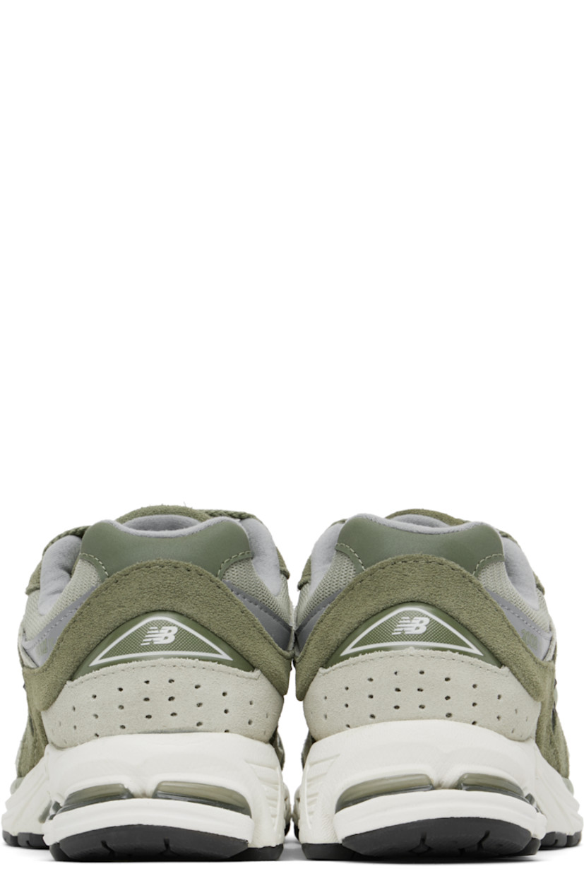 Low-top suede and mesh sneakers in khaki.

· Logo embroidered at vamp
· Lace-up closure
· Inset logo patch at padded tongue
· Padded collar
· Reflective logo appliqué at sides
· Perforated detailing at heel counter
· Jersey lining
· ABZORB® foam rubber midsole
· Treaded N-ergy rubber sole
· Stability Web technology at sole

Supplier color: Dark olivine/Olivine/Slate grey
