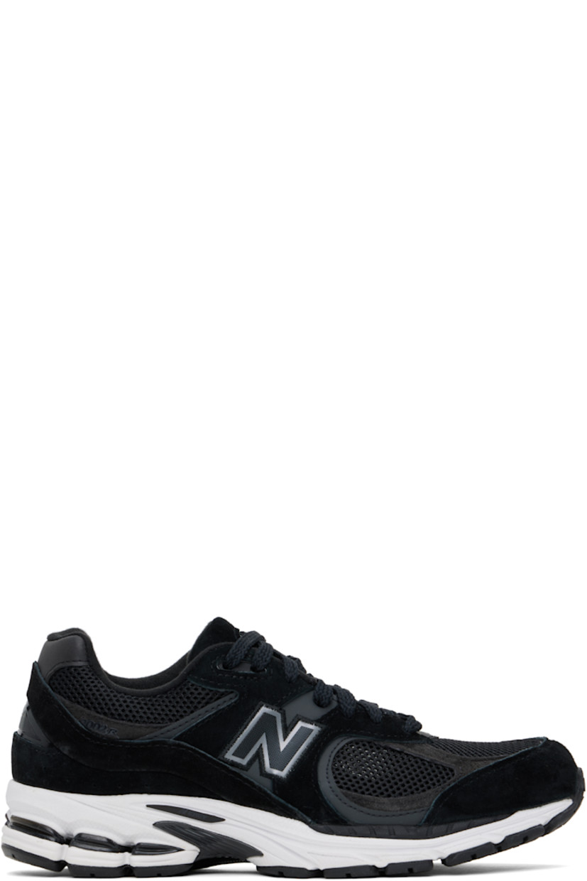 Low-top suede and mesh sneakers in black.

· Logo embroidered at vamp
· Lace-up closure
· Inset logo patch at padded tongue
· Padded collar
· Reflective logo appliqué at sides
· Perforated detailing at heel counter
· Jersey lining
· ABZORB® foam rubber midsole
· Treaded N-ergy rubber sole
· Stability Web technology at sole

Supplier color: Black/Phantom/Gunmetal