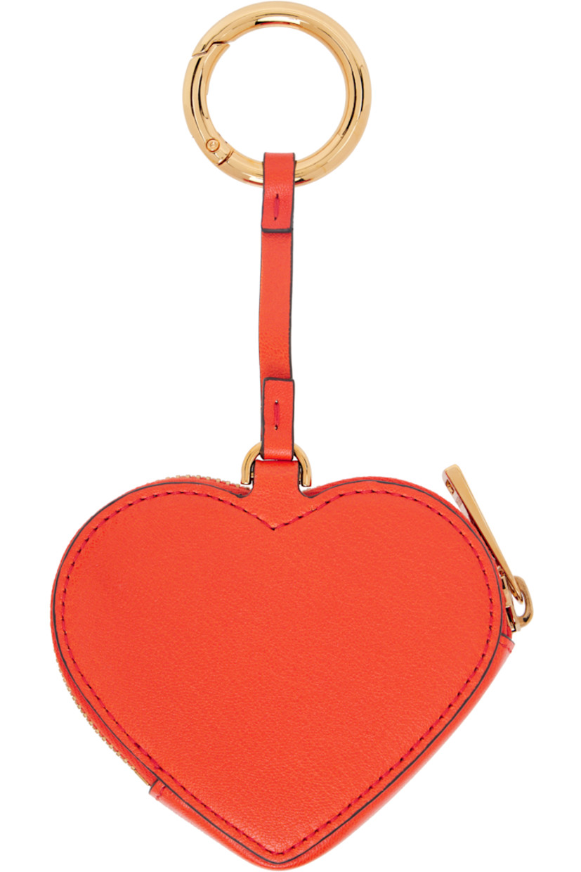 Grained lambskin coin pouch.

· Lanyard clasp at top 
· Logo hardware at face 
· Zip closure
· Logo-engraved gold-tone hardware
· H7.5" x W4" x D1"

Supplier color: Orange