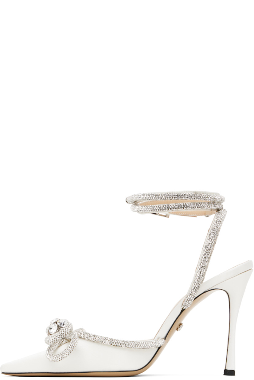 Silk satin heels in white.

· Crystal-cut detailing throughout
· Pointed toe
· Bow accent at vamp
· Wraparound pin-buckle ankle strap
· Logo stamp at padded leather footbed
· Buffed leather lining
· Covered stiletto heel with rubber injection
· Leather sole
· Heel: H4"

Supplier color: White