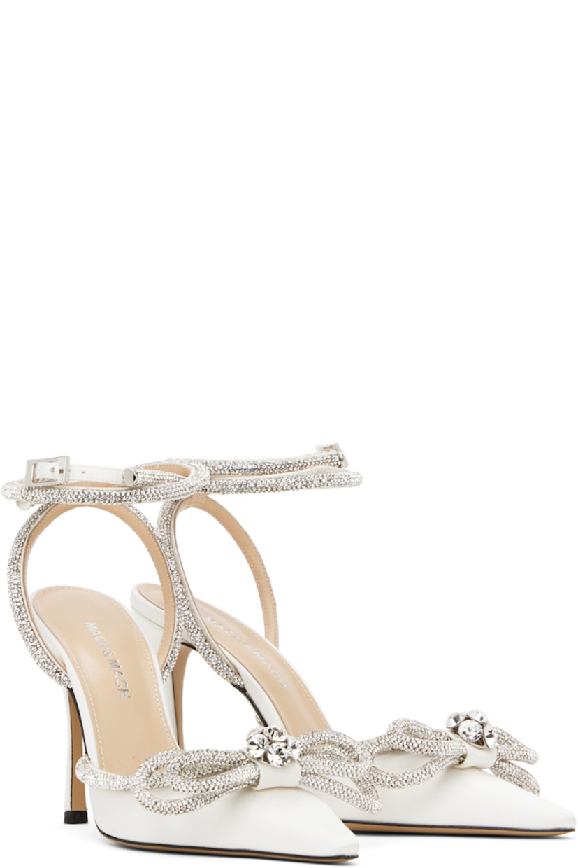 Silk satin heels in white.

· Crystal-cut detailing throughout
· Pointed toe
· Bow accent at vamp
· Wraparound pin-buckle ankle strap
· Logo stamp at padded leather footbed
· Buffed leather lining
· Covered stiletto heel with rubber injection
· Leather sole
· Heel: H4"

Supplier color: White