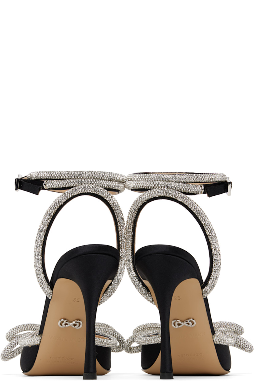 Silk satin heels in black.

· Crystal-cut detailing throughout
· Pointed toe
· Bow accent at vamp
· Wraparound pin-buckle ankle strap
· Logo stamp at padded leather footbed
· Buffed leather lining
· Covered stiletto heel with rubber injection
· Leather sole
· Heel: H4"

Supplier color: Black