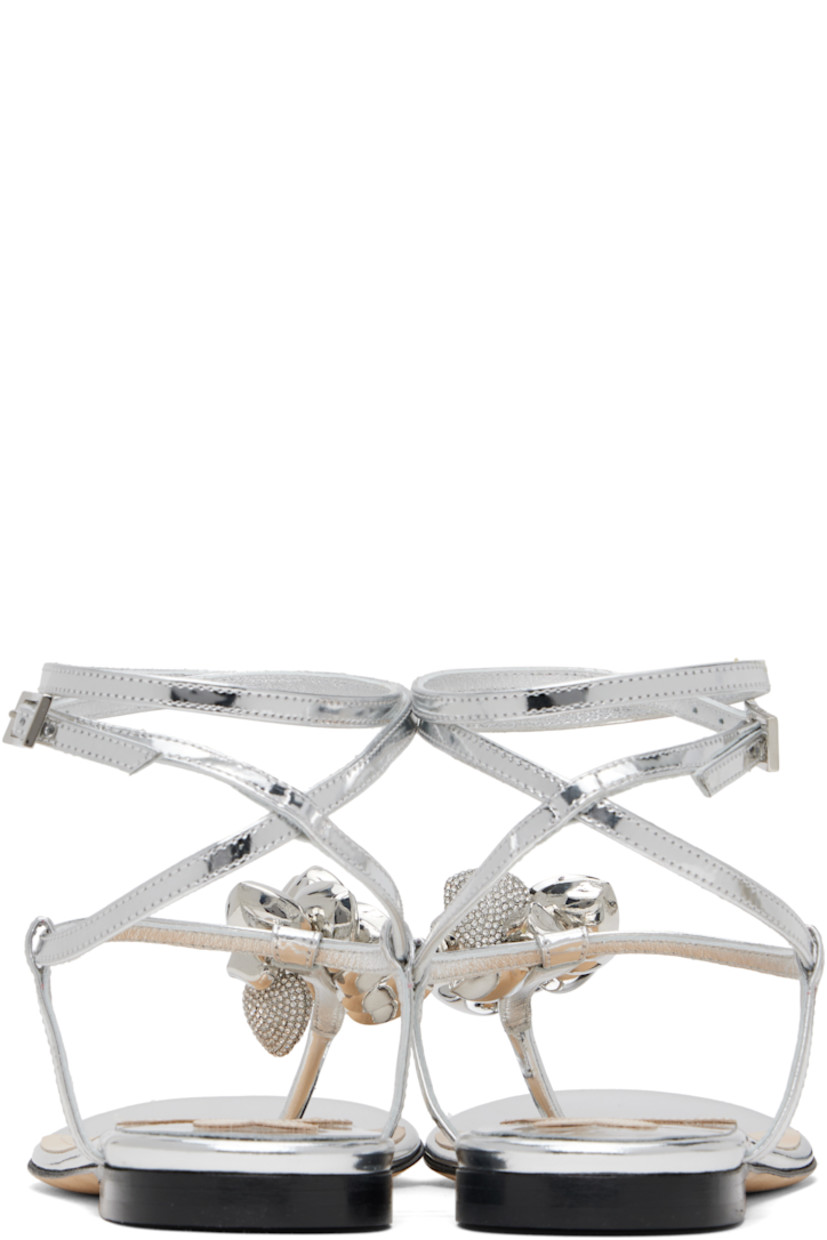 Patent leather flat sandals in silver tone.

· Graphic charms at thong-style strap
· Wraparound pin-buckle ankle strap
· Logo stamp at padded leather footbed
· Stacked leather heel with rubber injection
· Suede sole

Supplier color: Silver
