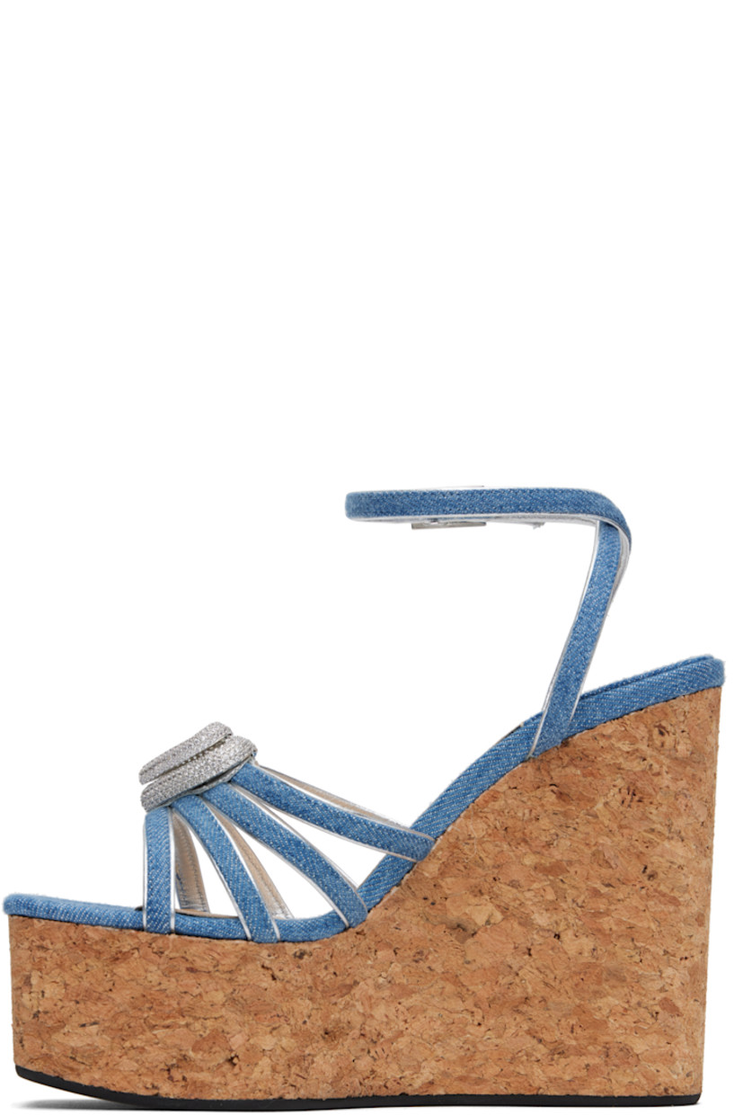 Denim heeled sandals in blue.

· Open square toe
· Straps and crystal-cut graphic hardware at vamp
· Pin-buckle ankle strap
· Logo stamp at padded footbed
· Grained leather lining
· Cork wedge heel and platform midsole
· Treaded rubber sole
· Platform: H2"
· Heel: H4.75"

Supplier color: Blue