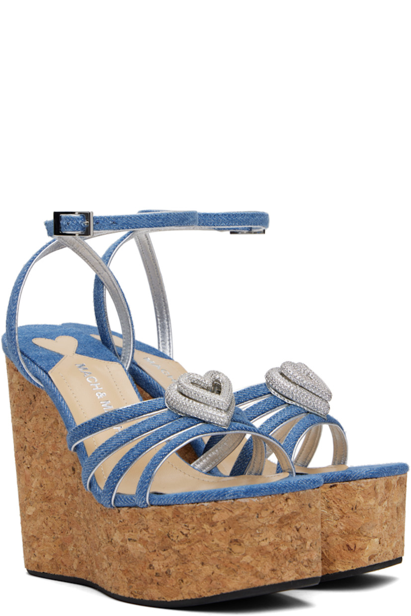 Denim heeled sandals in blue.

· Open square toe
· Straps and crystal-cut graphic hardware at vamp
· Pin-buckle ankle strap
· Logo stamp at padded footbed
· Grained leather lining
· Cork wedge heel and platform midsole
· Treaded rubber sole
· Platform: H2"
· Heel: H4.75"

Supplier color: Blue