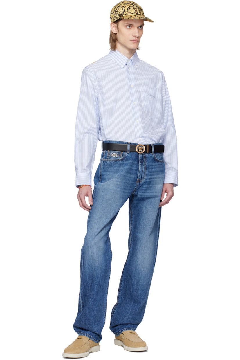 Cotton poplin shirt. Stripe pattern throughout.

· Button-down spread collar
· Button closure
· Logo and text embroidered at patch pocket
· Shirttail hem
· Buttoned barrel cuffs
· Logo graphic printed at silk poplin yoke

Supplier color: Pastel blue