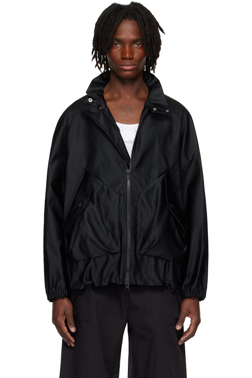 Polyester satin jacket.

· Bungee-style drawstring at stand collar, hem, and cuffs
· Two-way zip closure
· Flap pockets
· Gusset with eyelets at sides
· Raglan sleeves
· Storm flap at back yoke
· Logo-engraved hardware

Supplier color: Black