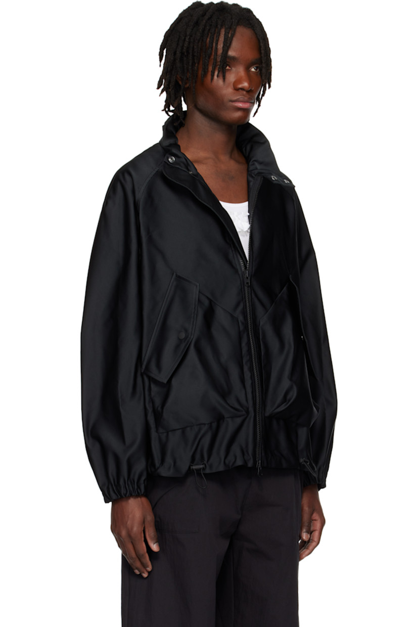 Polyester satin jacket.

· Bungee-style drawstring at stand collar, hem, and cuffs
· Two-way zip closure
· Flap pockets
· Gusset with eyelets at sides
· Raglan sleeves
· Storm flap at back yoke
· Logo-engraved hardware

Supplier color: Black