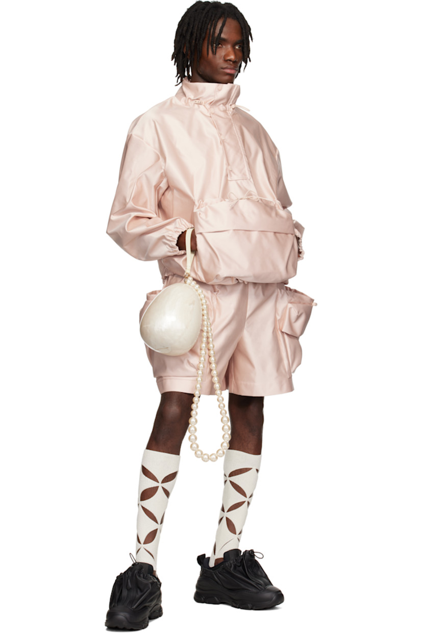 Polyester satin shorts. 

· Drawstring at elasticized waistband
· Bungee-style drawstring at patch pockets
· Flap pockets 

Supplier color: Powder pink