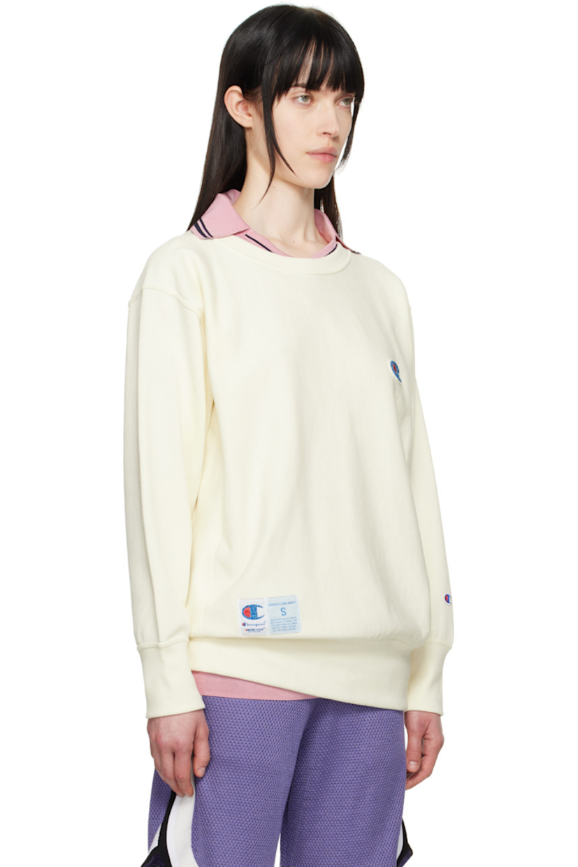 French terry sweatshirt.

· Rib-knit crewneck, hem, and cuffs
· Felted and beaded logo patch at chest
· Logo patch at front hem
· Logo embroidered at cuff
· Dropped shoulder

Part of the UNDERCOVER x Champion collaboration.

Supplier color: Ivory