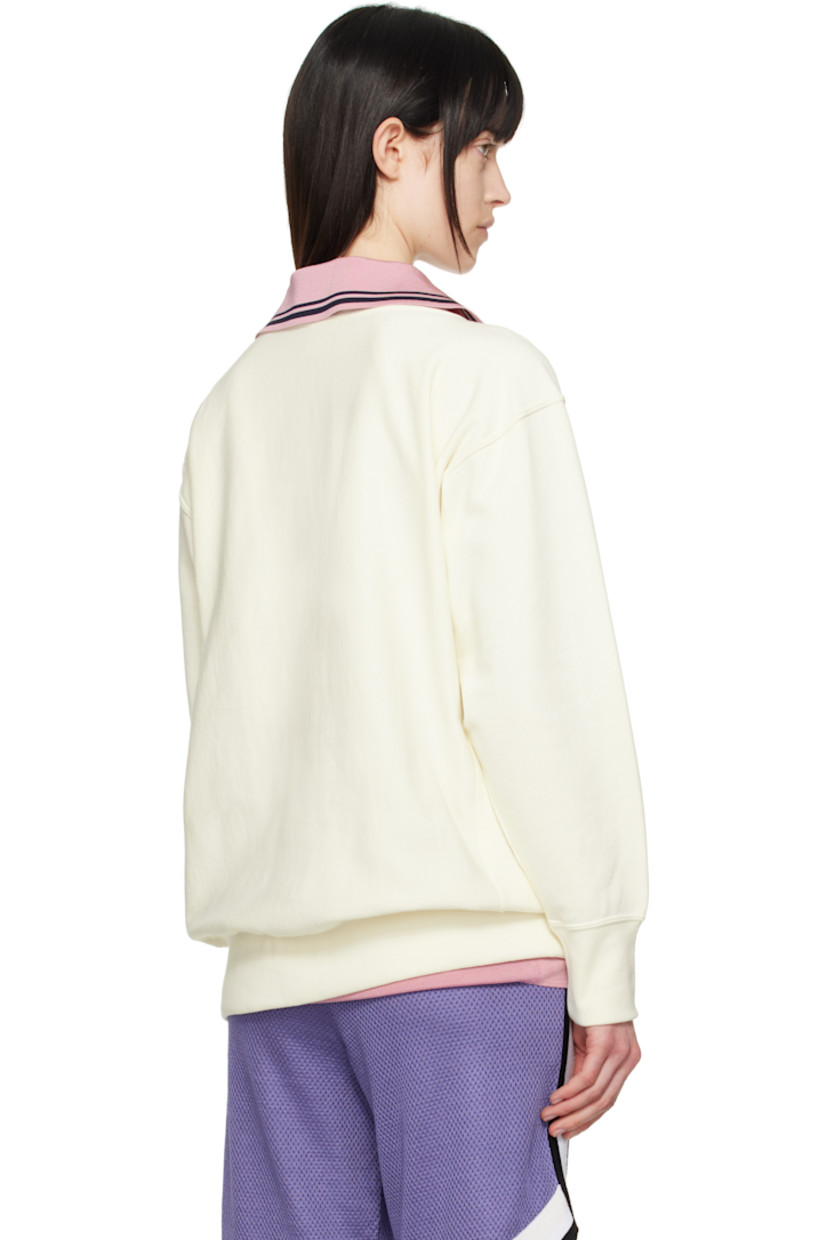 French terry sweatshirt.

· Rib-knit crewneck, hem, and cuffs
· Felted and beaded logo patch at chest
· Logo patch at front hem
· Logo embroidered at cuff
· Dropped shoulder

Part of the UNDERCOVER x Champion collaboration.

Supplier color: Ivory