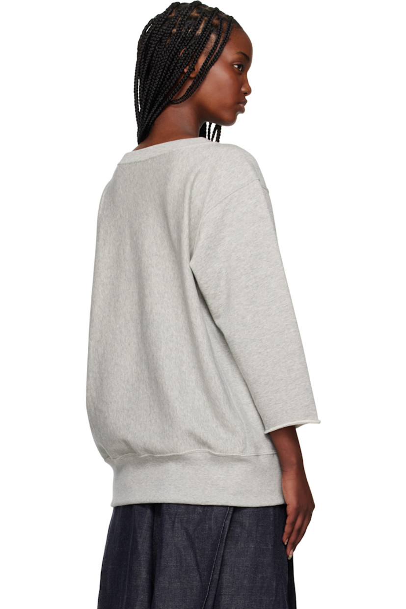 French terry sweatshirt.

· Rib-knit crewneck and hem 
· Text printed at front
· Logo patch at hem 
· Dropped shoulders
· Embroidered logo patch at cuff
· Rolled edge at cuffs

Part of the UNDERCOVER x Champion collaboration.

Supplier color: Top gray