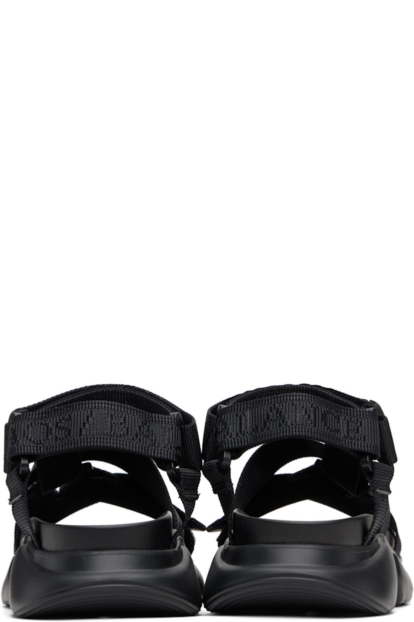 Logo-woven nylon webbing sandals in black.

· Open toe
· Crisscrossing velcro straps at vamp
· Logo flag at velcro ankle strap
· Molded rubber footbed
· Treaded rubber sole

Supplier color: Black