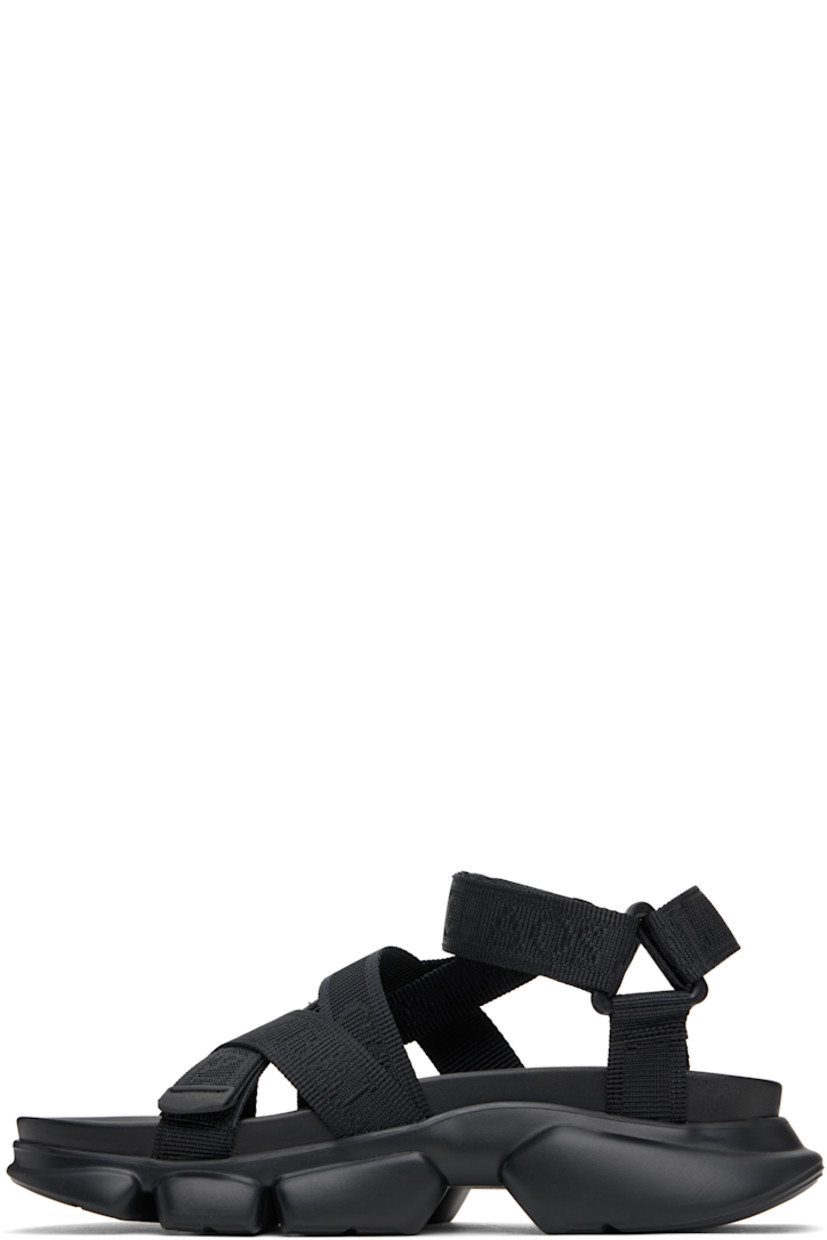 Logo-woven nylon webbing sandals in black.

· Open toe
· Crisscrossing velcro straps at vamp
· Logo flag at velcro ankle strap
· Molded rubber footbed
· Treaded rubber sole

Supplier color: Black