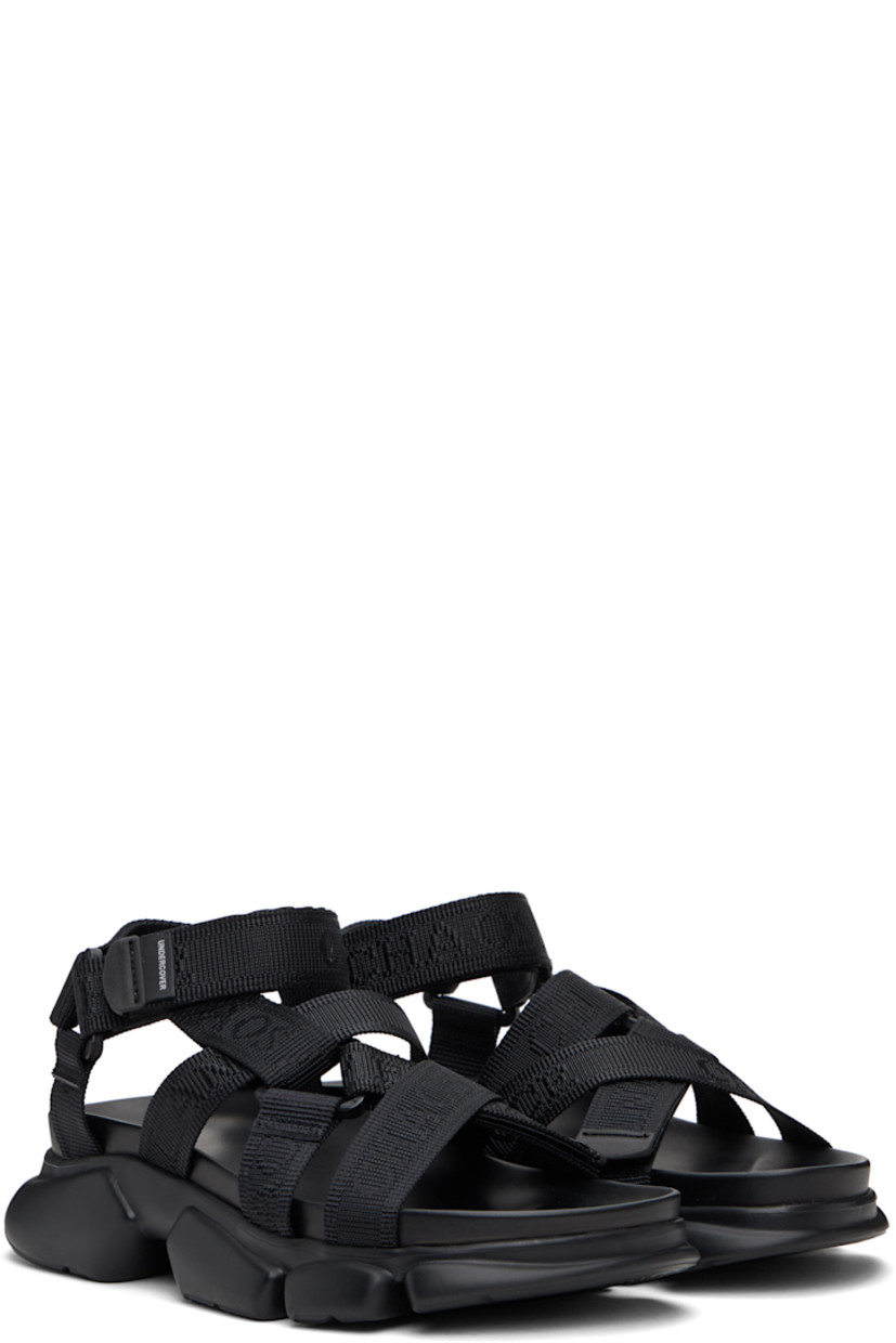 Logo-woven nylon webbing sandals in black.

· Open toe
· Crisscrossing velcro straps at vamp
· Logo flag at velcro ankle strap
· Molded rubber footbed
· Treaded rubber sole

Supplier color: Black