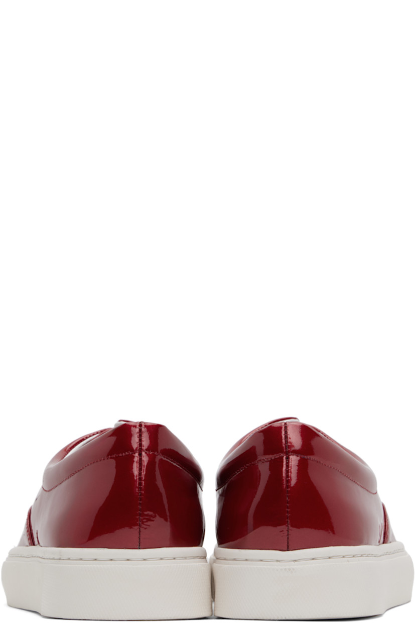 Low-top patent sheepskin sneakers in red.

· Lace-up closure
· Padded collar
· Buffed leather and canvas lining
· Treaded Vibram® rubber sole

Supplier color: Red