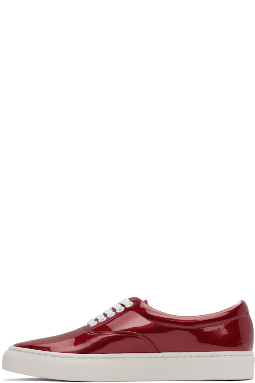 Low-top patent sheepskin sneakers in red.

· Lace-up closure
· Padded collar
· Buffed leather and canvas lining
· Treaded Vibram® rubber sole

Supplier color: Red