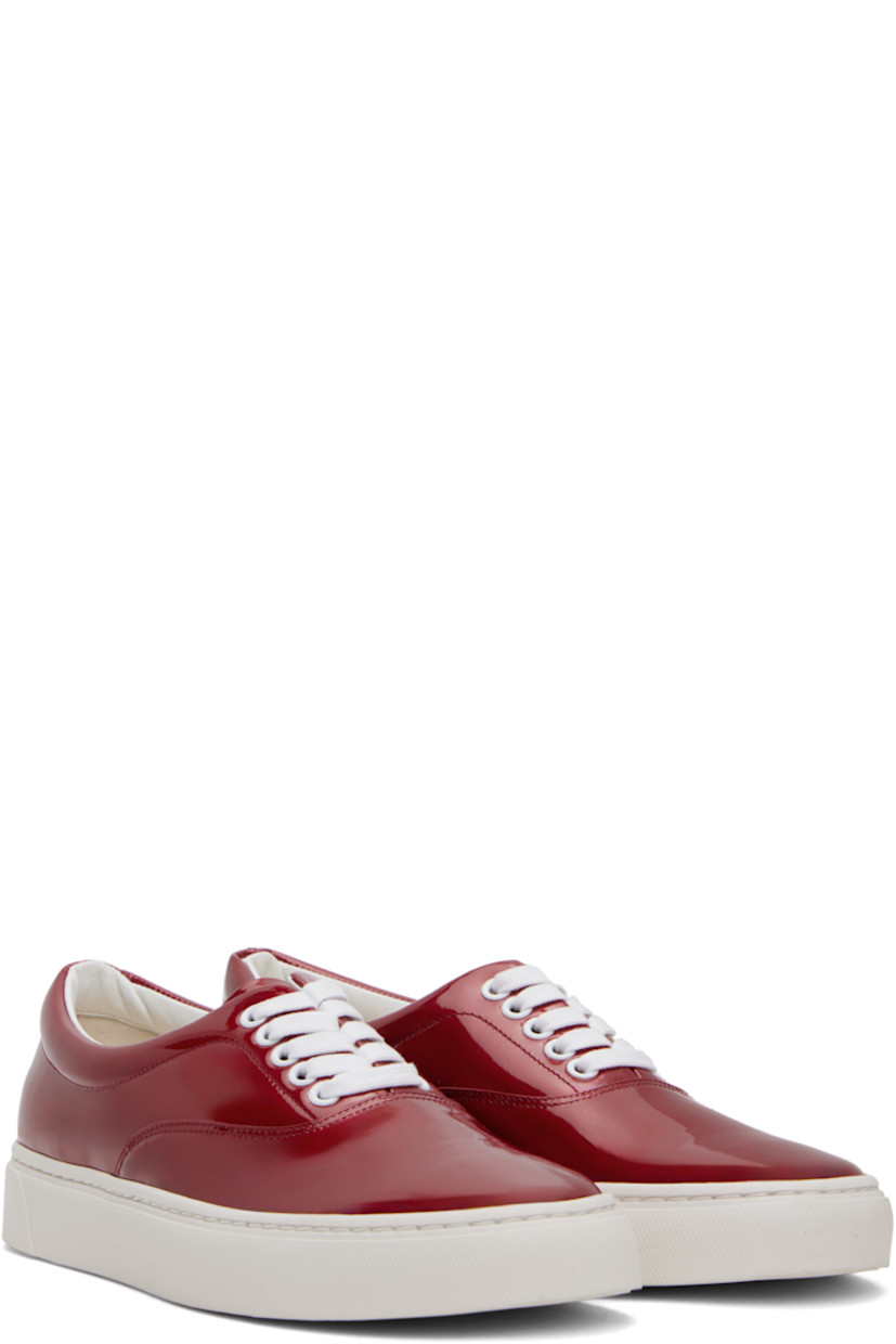 Low-top patent sheepskin sneakers in red.

· Lace-up closure
· Padded collar
· Buffed leather and canvas lining
· Treaded Vibram® rubber sole

Supplier color: Red