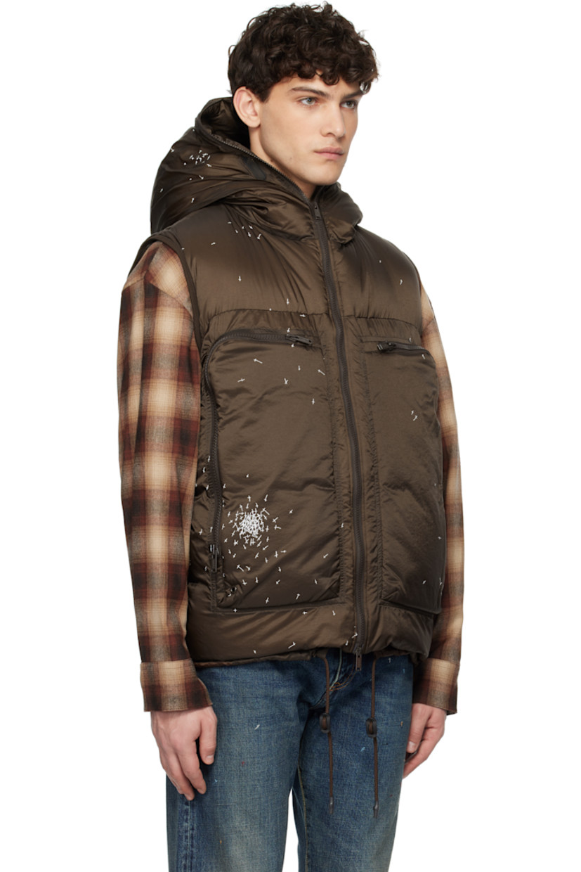 Down-filled and quilted nylon satin vest. Graphics printed throughout.

· Mesh trim at hood
· Two-way zip closure extends to hood
· Eyelet at zip pockets
· Cord-lock drawstring at hem
· Elasticized armscyes
· Patch pockets at interior
· Fully lined

Supplier color: Brown

Fill: 90% down, 10% feather.