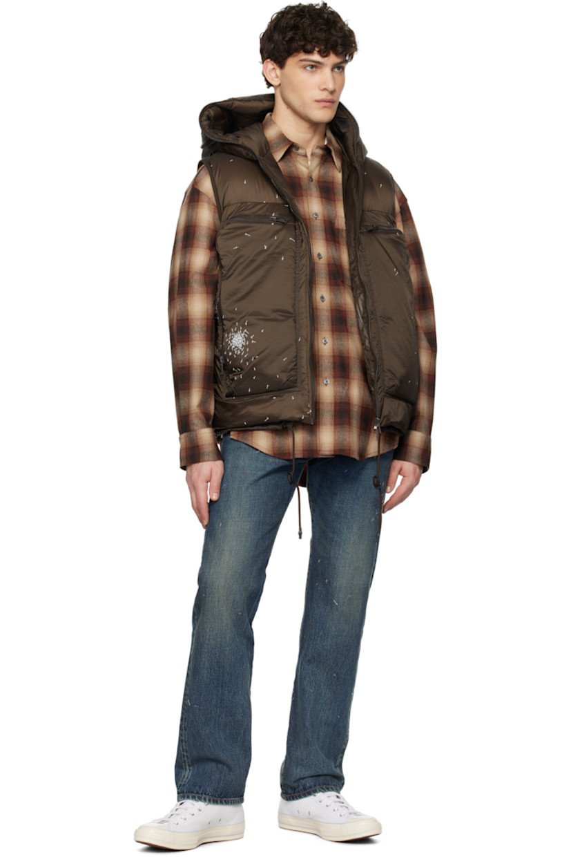 Down-filled and quilted nylon satin vest. Graphics printed throughout.

· Mesh trim at hood
· Two-way zip closure extends to hood
· Eyelet at zip pockets
· Cord-lock drawstring at hem
· Elasticized armscyes
· Patch pockets at interior
· Fully lined

Supplier color: Brown

Fill: 90% down, 10% feather.