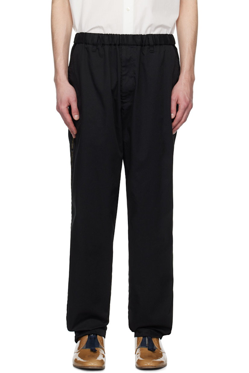 Polyester- and cotton-blend twill trousers.

· Concealed drawstring at elasticized waistband
· Belt loops
· Four-pocket styling
· Zip-fly
· Text-woven stripe at outseams

Supplier color: Black
