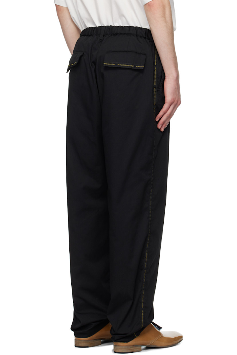 Polyester- and cotton-blend twill trousers.

· Concealed drawstring at elasticized waistband
· Belt loops
· Four-pocket styling
· Zip-fly
· Text-woven stripe at outseams

Supplier color: Black