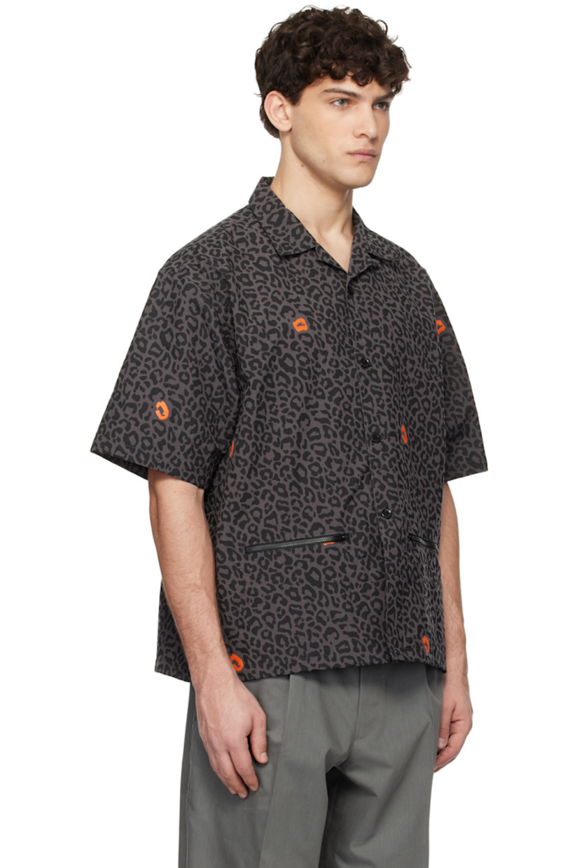 Nylon duck canvas shirt. Leopard pattern printed throughout.

· Open spread collar
· Button closure
· Zip pockets
· Logo flag at side seam
· Vented side seams

Supplier color: Gray