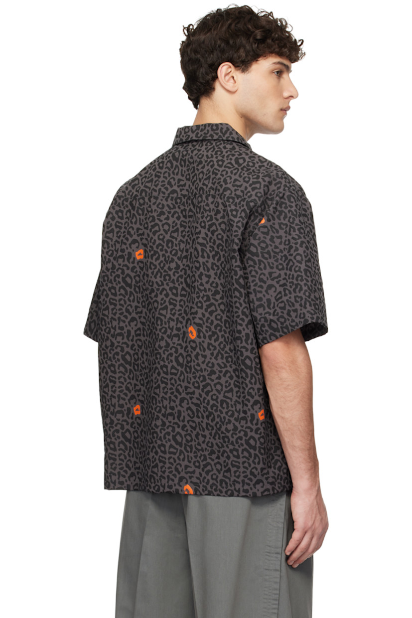 Nylon duck canvas shirt. Leopard pattern printed throughout.

· Open spread collar
· Button closure
· Zip pockets
· Logo flag at side seam
· Vented side seams

Supplier color: Gray