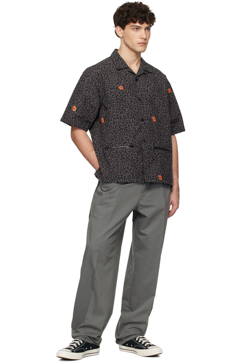 Nylon duck canvas shirt. Leopard pattern printed throughout.

· Open spread collar
· Button closure
· Zip pockets
· Logo flag at side seam
· Vented side seams

Supplier color: Gray