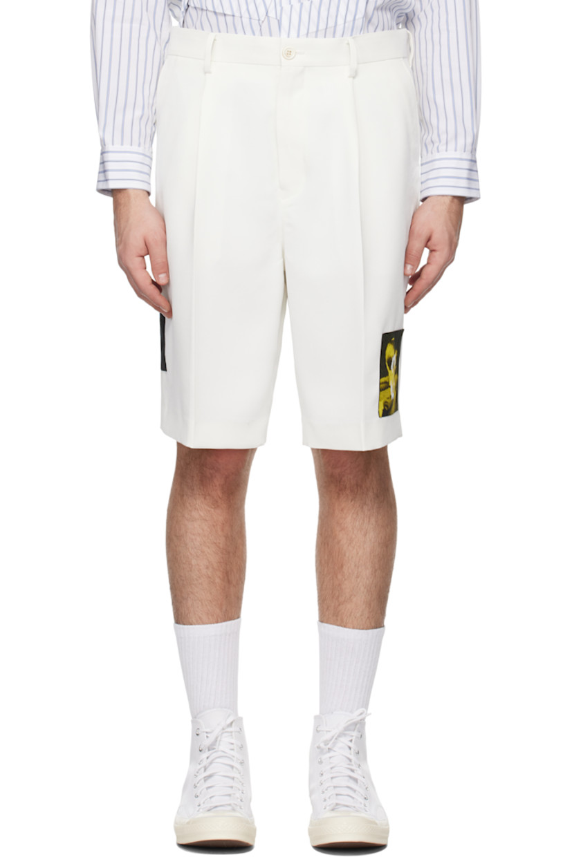 Polyester twill shorts.

· Belt loops
· Four-pocket styling
· Zip-fly
· Pleats at front
· Appliqué at leg and outseam
· Creased legs

Supplier color: White