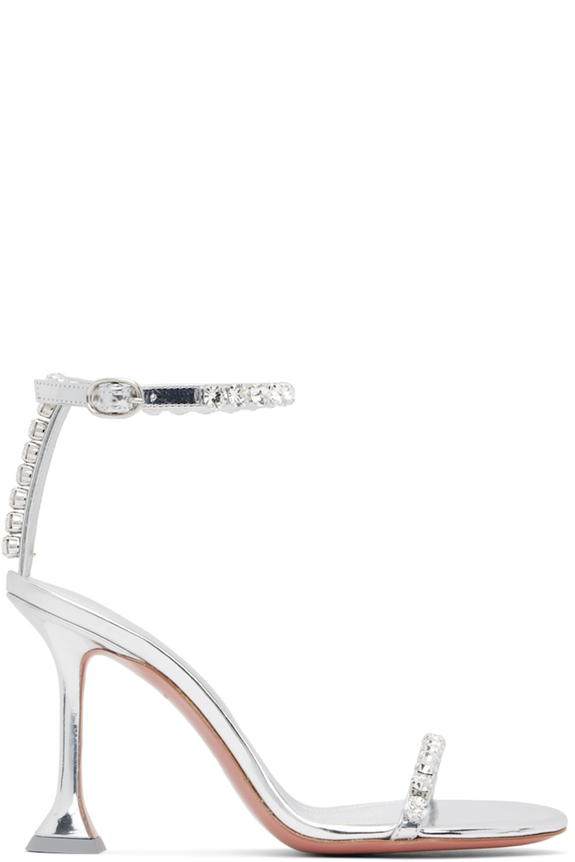 Patent calfskin heeled sandals in silver tone.

· Crystal-cut accents throughout
· Open toe
· Strap at vamp
· Pin-buckle ankle strap
· Logo-embossed goatskin footbed
· Covered spool heel with rubber injection
· Polished leather sole with rubber injection
· Heel: H3.75"

Supplier color: Mirror silver/White crystal