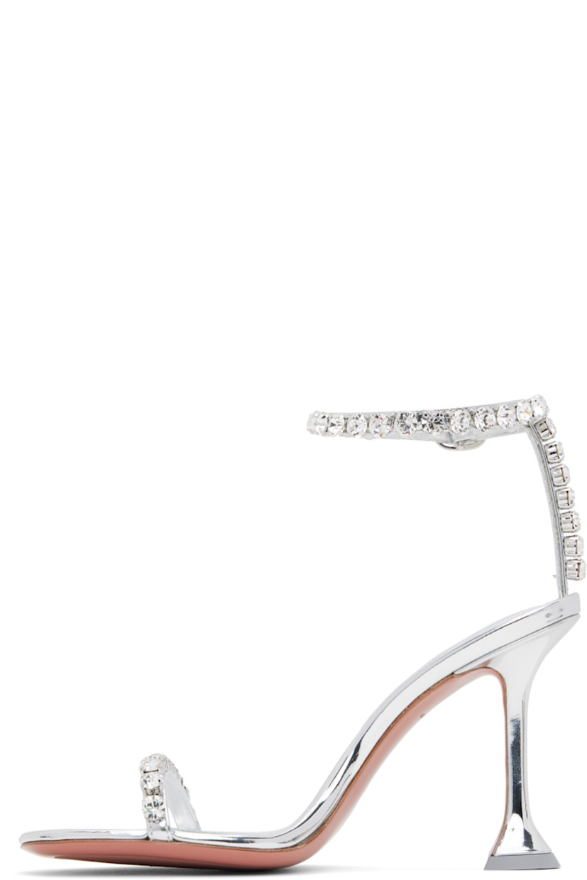 Patent calfskin heeled sandals in silver tone.

· Crystal-cut accents throughout
· Open toe
· Strap at vamp
· Pin-buckle ankle strap
· Logo-embossed goatskin footbed
· Covered spool heel with rubber injection
· Polished leather sole with rubber injection
· Heel: H3.75"

Supplier color: Mirror silver/White crystal