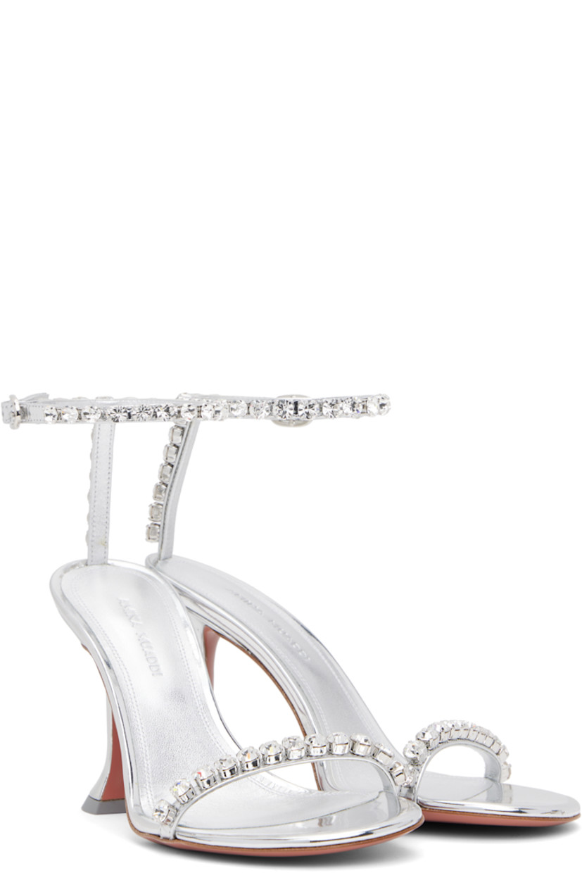 Patent calfskin heeled sandals in silver tone.

· Crystal-cut accents throughout
· Open toe
· Strap at vamp
· Pin-buckle ankle strap
· Logo-embossed goatskin footbed
· Covered spool heel with rubber injection
· Polished leather sole with rubber injection
· Heel: H3.75"

Supplier color: Mirror silver/White crystal