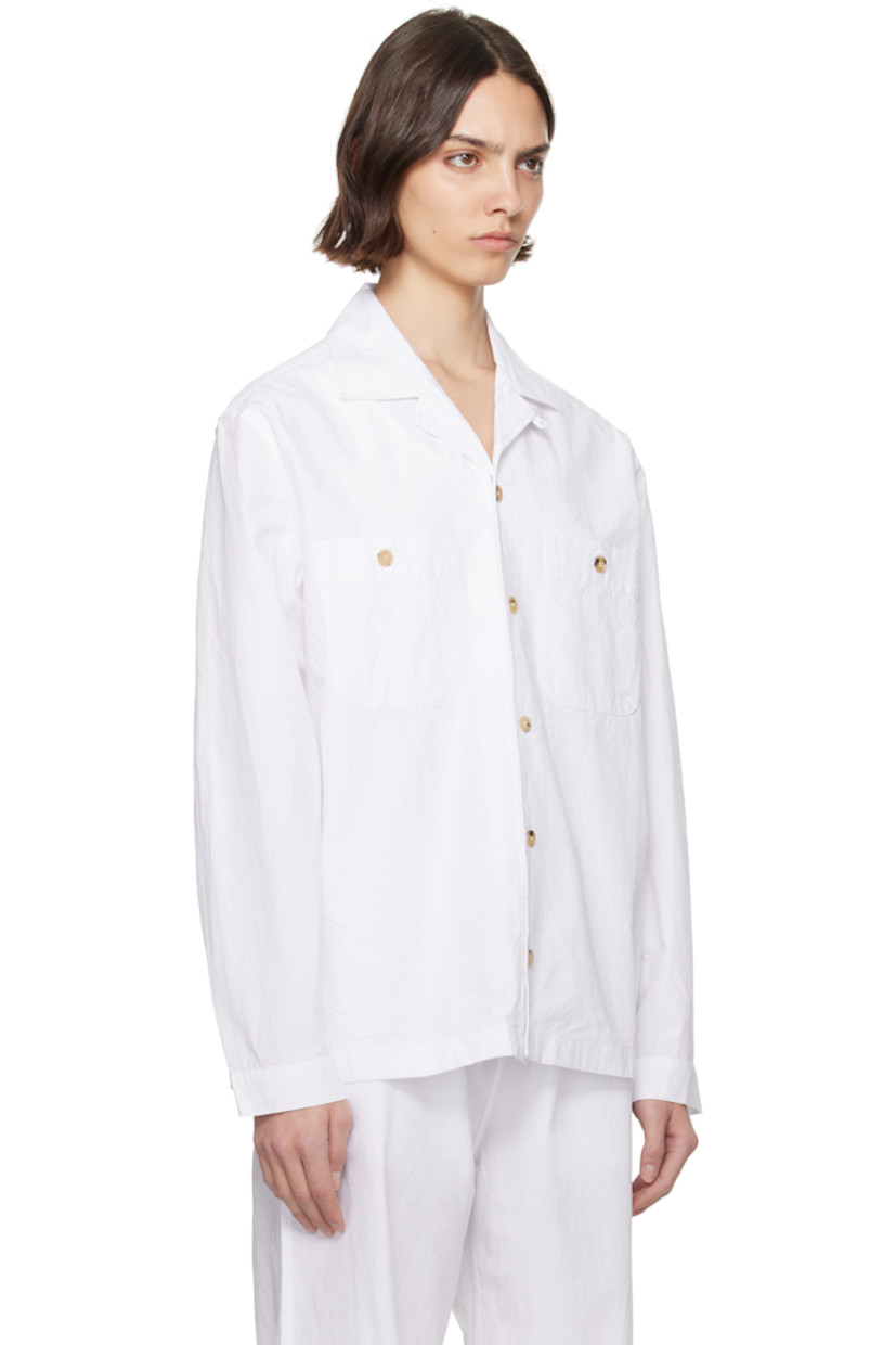 Crinkled organic cotton twill overshirt.

· Spread collar
· Button closure
· Patch pockets at chest
· Adjustable buttoned barrel cuffs
· Box pleat at back yoke
· Horn hardware

Supplier color: Off white