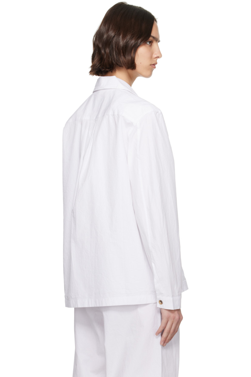 Crinkled organic cotton twill overshirt.

· Spread collar
· Button closure
· Patch pockets at chest
· Adjustable buttoned barrel cuffs
· Box pleat at back yoke
· Horn hardware

Supplier color: Off white