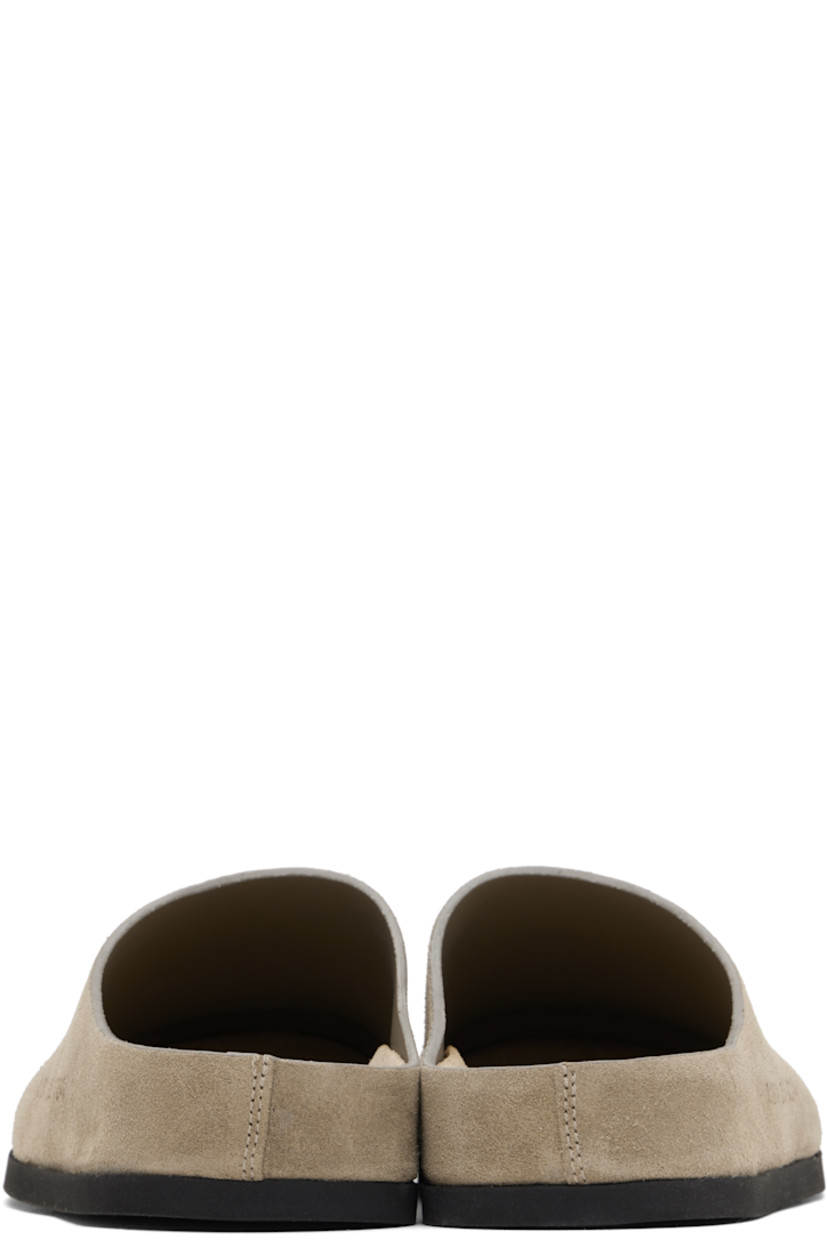 Suede slip-on loafers in taupe.

· Signature series embossed at outer side
· Logo stamp at molded suede footbed
· Buffed leather lining
· Rubber sole

Supplier color: Taupe