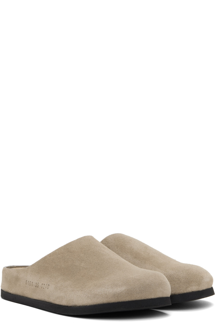 Suede slip-on loafers in taupe.

· Signature series embossed at outer side
· Logo stamp at molded suede footbed
· Buffed leather lining
· Rubber sole

Supplier color: Taupe