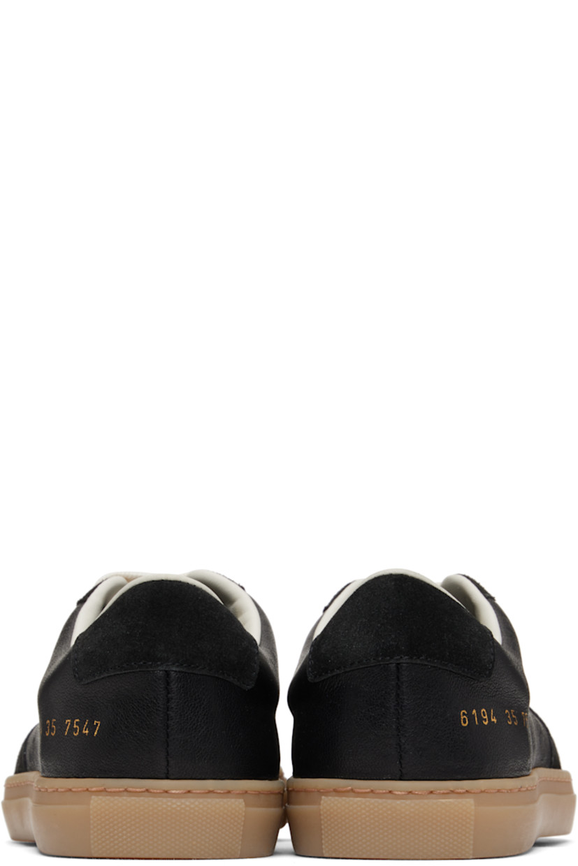 Low-top grained leather and suede sneakers in black.

· Perforations at toe and outer side
· Lace-up closure
· Padded tongue and collar
· Signature series stamp at outer side
· Buffed leather and mesh lining
· Treaded rubber sole

Supplier color: Black