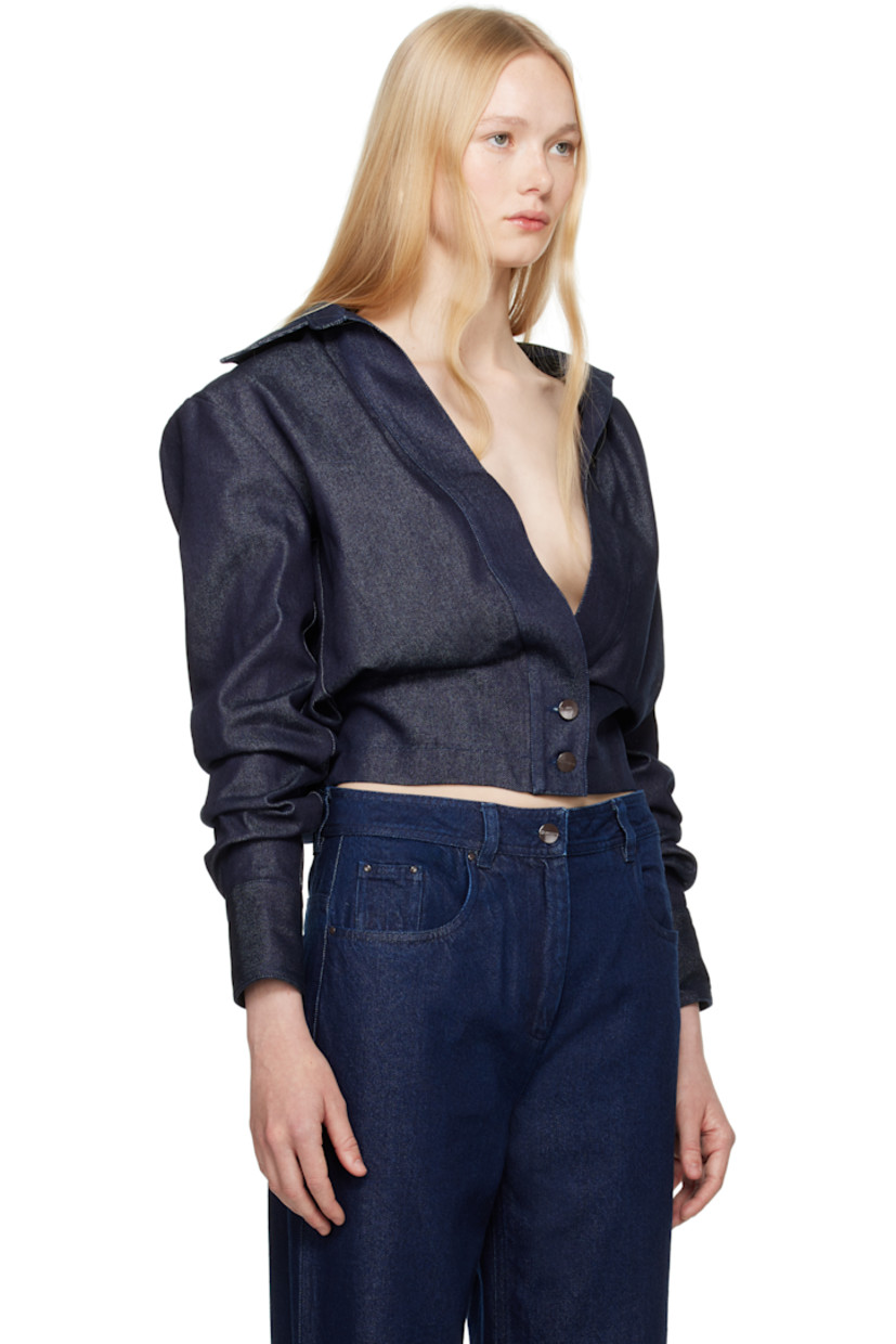 Non-stretch cotton- and lyocell-blend denim jacket.

· Spread collar
· Tucks at open front
· Button fastening at front hem
· Dropped shoulders
· Gathering at sleeves
· Pleat at buttoned barrel cuffs
· Mock button tabs at elasticized back hem
· Full satin lining
· Logo-engraved gunmetal-tone hardware

Supplier color: Blue